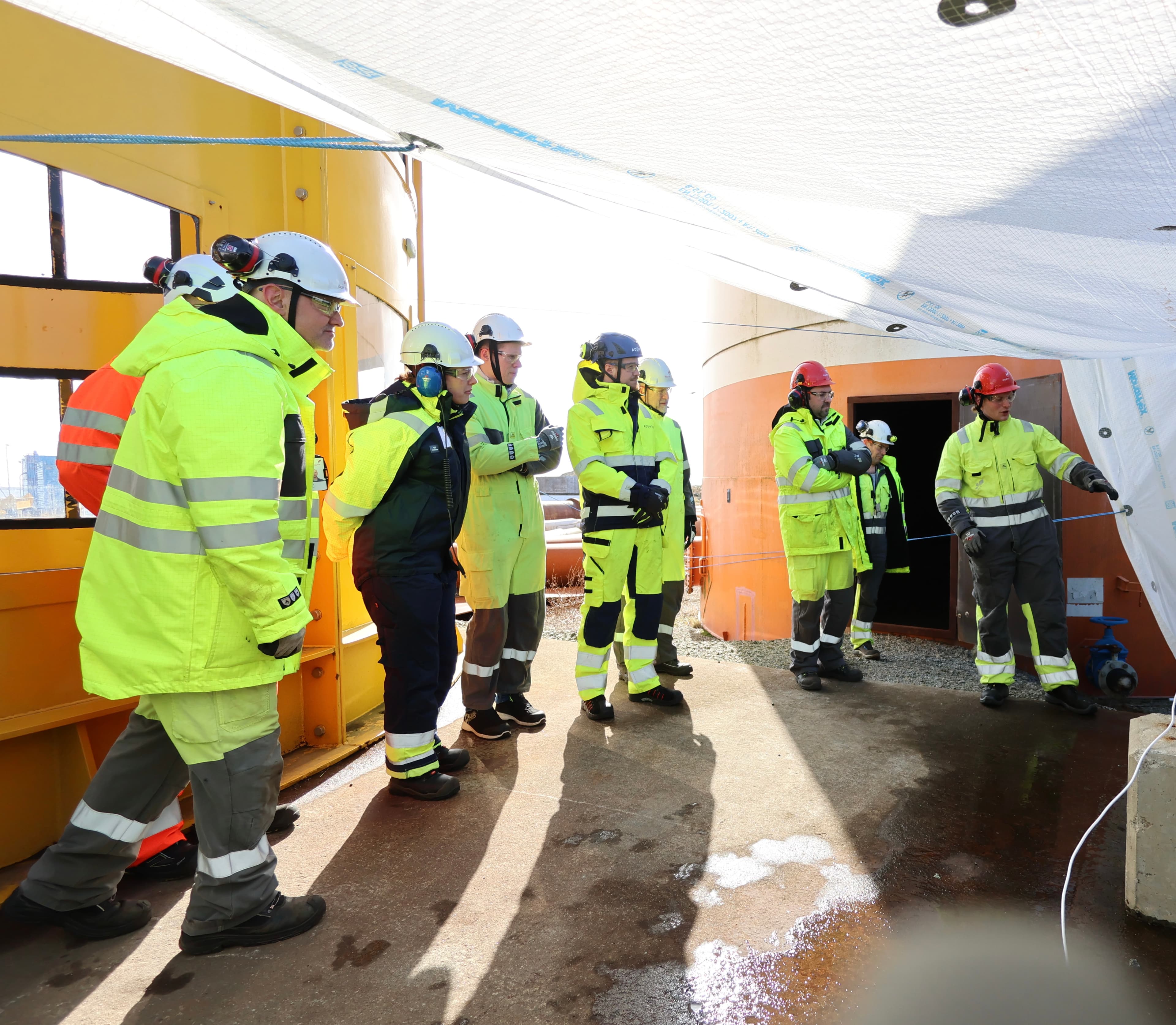 Team of workers gathered on deck at a transfer terminal